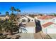 Two-story house with tile roof and attached garage, desert landscape at 1608 Council Bluff Ln, North Las Vegas, NV 89031