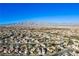 Wide aerial view of houses with mountain backdrop at 1608 Council Bluff Ln, North Las Vegas, NV 89031