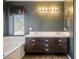 Double sink bathroom with dark wood cabinets at 1608 Council Bluff Ln, North Las Vegas, NV 89031