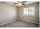 Simple bedroom with ceiling fan and carpet flooring at 1608 Council Bluff Ln, North Las Vegas, NV 89031