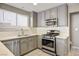 Updated kitchen with gray cabinets, white tile backsplash at 1608 Council Bluff Ln, North Las Vegas, NV 89031