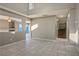 Two-story living room with tile floors and open staircase at 1608 Council Bluff Ln, North Las Vegas, NV 89031