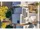 Birds eye view of the roof of a home with solar panels and a green backyard with a patio and trees at 1610 Dire Wolf Avenue, North Las Vegas, NV 89084