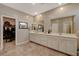 Bathroom with a long dual sink vanity, and a walk-in closet located through a door to the left at 1610 Dire Wolf Avenue, North Las Vegas, NV 89084