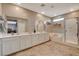 Modern bathroom with double vanity, soaking tub, and walk-in shower featuring glass enclosure at 1610 Dire Wolf Avenue, North Las Vegas, NV 89084