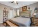 A nicely decorated bedroom with wood-look floors, ceiling fan, decorative shelving, and a large wooden headboard at 1610 Dire Wolf Avenue, North Las Vegas, NV 89084