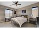 Bedroom with a desk, two nightstands, a ceiling fan, and decorative wildlife artwork at 1610 Dire Wolf Avenue, North Las Vegas, NV 89084