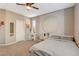 Comfortable bedroom featuring soft carpet, ceiling fan, and lots of natural light at 1610 Dire Wolf Avenue, North Las Vegas, NV 89084