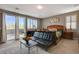 Bright bedroom showcasing a sliding glass door to a balcony, shutters, and contemporary furnishings at 1610 Dire Wolf Avenue, North Las Vegas, NV 89084