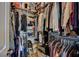 A walk-in closet featuring organized shelves and clothing racks filled with a variety of garments at 1610 Dire Wolf Avenue, North Las Vegas, NV 89084