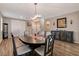 Formal dining room with dark wood table, chandelier, hardwood floors, and built-in cabinets at 1610 Dire Wolf Avenue, North Las Vegas, NV 89084