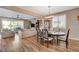 Open concept dining room with dark wood table, chandelier, and hardwood floors at 1610 Dire Wolf Avenue, North Las Vegas, NV 89084