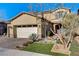 Two-story home with desert landscaping, stone accents, and a paver driveway leading to a two-car garage at 1610 Dire Wolf Avenue, North Las Vegas, NV 89084