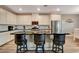 Modern kitchen with white cabinetry, stainless steel appliances, a central island, and barstool seating at 1610 Dire Wolf Avenue, North Las Vegas, NV 89084