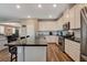 Modern kitchen with white cabinets, granite countertops, and stainless steel appliances at 1610 Dire Wolf Avenue, North Las Vegas, NV 89084