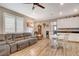 Combined kitchen and living area with wood floors and white cabinets at 1610 Dire Wolf Avenue, North Las Vegas, NV 89084