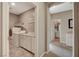 Well lit laundry room with modern washer and dryer and a view into the bathroom at 1610 Dire Wolf Avenue, North Las Vegas, NV 89084