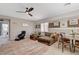 Open-concept living room with neutral tones, ceiling fan, and comfortable seating arrangement at 1610 Dire Wolf Avenue, North Las Vegas, NV 89084