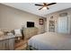 Main bedroom features a ceiling fan, wood-look flooring, and neutral paint at 1610 Dire Wolf Avenue, North Las Vegas, NV 89084