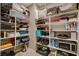 Organized pantry with shelving filled with containers and storage items, including a microwave at 1610 Dire Wolf Avenue, North Las Vegas, NV 89084