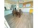 Dining room with wood-look floors and a dark wood table at 1695 Westwind Rd, Las Vegas, NV 89146