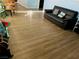 Living room with dark brown floors and a black leather couch at 1695 Westwind Rd, Las Vegas, NV 89146