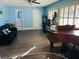 Living room with light blue walls, wood-look floors, and a piano at 1695 Westwind Rd, Las Vegas, NV 89146