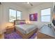 Bright bedroom with wood bed frame, purple rug, and window at 210 Bella Noche St, Las Vegas, NV 89138