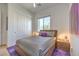 Bedroom with wood bed frame, purple rug, and window at 210 Bella Noche St, Las Vegas, NV 89138