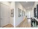 Bright hallway with light wood floors and modern art at 210 Bella Noche St, Las Vegas, NV 89138