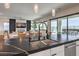 Modern kitchen with a double sink, black countertops, and open layout at 210 Bella Noche St, Las Vegas, NV 89138