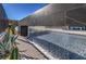 Modern pool with waterfall feature and desert landscaping at 210 Bella Noche St, Las Vegas, NV 89138