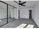 Primary bedroom with mirrored closet and ceiling fan at 2157 Wagonwheel Ave, Las Vegas, NV 89119