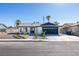 Remodeled single story home with dark gray garage door and landscaped yard at 2157 Wagonwheel Ave, Las Vegas, NV 89119