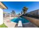 Inviting kidney-shaped pool with diving board, surrounded by a block wall and landscaping at 2157 Wagonwheel Ave, Las Vegas, NV 89119