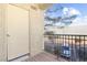 Small balcony with door access and partial view of parking lot at 2801 N Rainbow Blvd # 235, Las Vegas, NV 89108