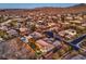 Expansive aerial view of the neighborhood with lush landscaping, mature trees, and mountain views in the background at 3 Pine Hollow Dr, Henderson, NV 89052