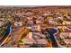 Expansive aerial view showcasing a desert community neighborhood with well-maintained homes, desert landscaping, and stunning mountain views at 3 Pine Hollow Dr, Henderson, NV 89052