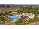 Aerial view of a community pool and clubhouse, surrounded by lush greenery and scenic landscape at 3 Pine Hollow Dr, Henderson, NV 89052