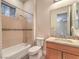 Well-lit bathroom featuring shower-tub combo and modern vanity at 3 Pine Hollow Dr, Henderson, NV 89052