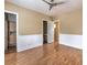 Bedroom with wainscoting, light hardwood floors, and access to ensuite bathroom and walk-in closet at 3 Pine Hollow Dr, Henderson, NV 89052