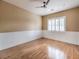 Inviting bedroom featuring hardwood floors, large window with shutters, and beadboard wainscoting at 3 Pine Hollow Dr, Henderson, NV 89052