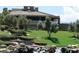 Clubhouse exterior showcasing a landscaped lawn, rock features, and modern architecture at 3 Pine Hollow Dr, Henderson, NV 89052