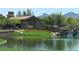 Clubhouse entry with covered walkway over the water feature, and lush landscaping at 3 Pine Hollow Dr, Henderson, NV 89052