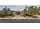 Beautiful single story house with mature trees, decorative entry gate and stone exterior at 3 Pine Hollow Dr, Henderson, NV 89052