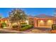 Attractive home exterior with a stone facade, well-kept landscaping, and a paved driveway at 3 Pine Hollow Dr, Henderson, NV 89052