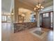 Inviting foyer featuring a stone accent wall, decorative chandelier, and tile flooring at 3 Pine Hollow Dr, Henderson, NV 89052