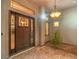 Elegant front entrance with a custom door, decorative windows, and unique lighting at 3 Pine Hollow Dr, Henderson, NV 89052