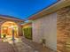 Charming home exterior with a stone archway, mature landscaping, and inviting curb appeal at 3 Pine Hollow Dr, Henderson, NV 89052