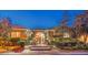 Inviting home exterior with stone accents, mature trees, and manicured landscaping at 3 Pine Hollow Dr, Henderson, NV 89052